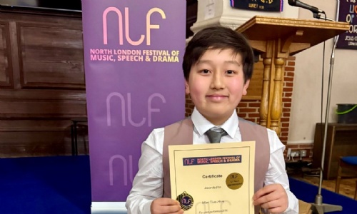 Max posing with his winning certificate